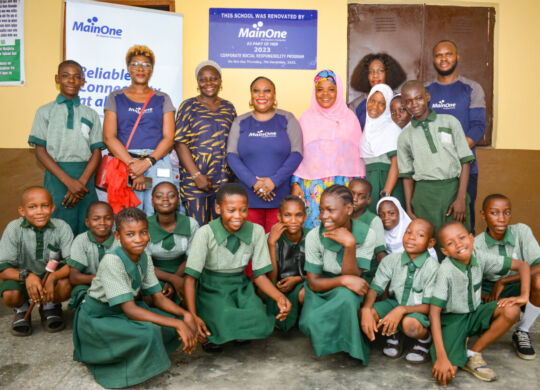 L-R: Molade Ajidahun, Head, Corporate & Commercial Services, MainOne; Hon. Rasak Abidemi representing the local govt chairman, Christiana Okenla, Head, Customer Experience, MainOne; Mrs. T. M. Bakare, Principal, Akinlade Nursery and Primary School and Omolola Akintomide, Head, Support Services, MainOne –with some of the students and the MainOne team at the handover ceremony recently.